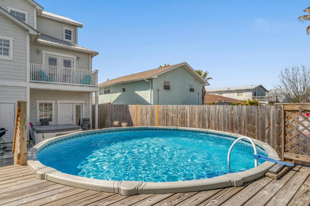 a swimming pool on a deck next to a fence at Blue Oasis Beach Vacation Home with Private Pool & Hot Tub in Panama City Beach