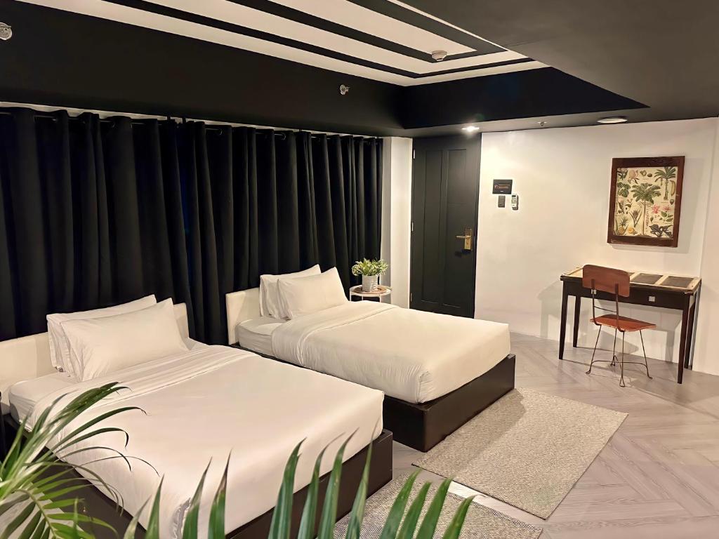 Postel nebo postele na pokoji v ubytování Havitat Boutique Hotel