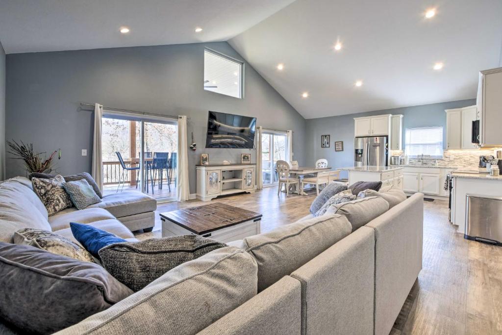 a living room with a large couch and a kitchen at Waterfront Home on Lake Milton Dock, Hot Tub in Lake Milton
