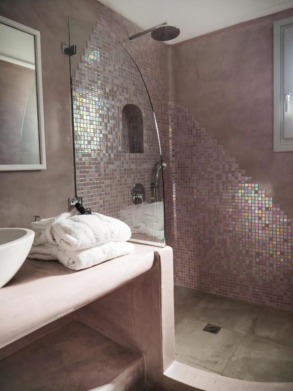 a bathroom with a shower and a sink at Vitsentzos Suites in Imerovigli