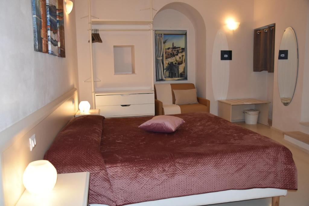 a bedroom with a bed with a pink pillow on it at Il Belvedere in Matera