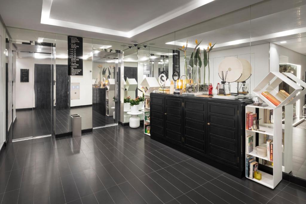a large room with a black vanity and mirrors at LHP Napoli Palace & SPA in Naples