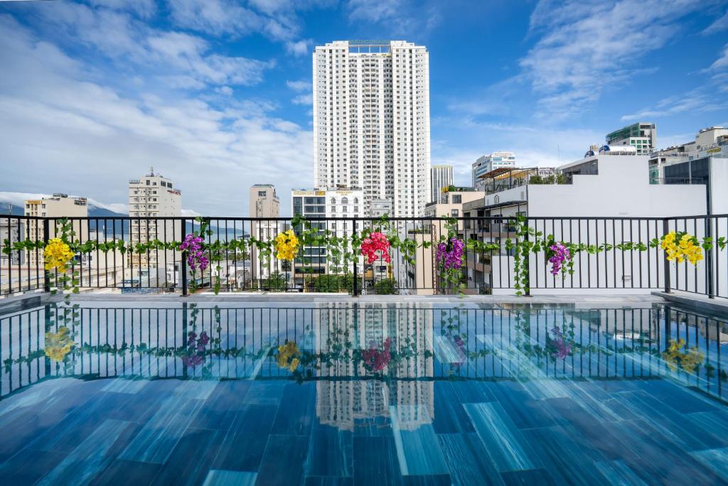 a swimming pool with a city skyline in the background at Samatha Apartment & Hotel in Da Nang