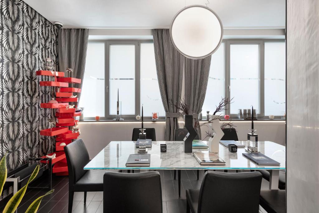 a dining room with a glass table and chairs at LHP Napoli Palace & SPA in Naples