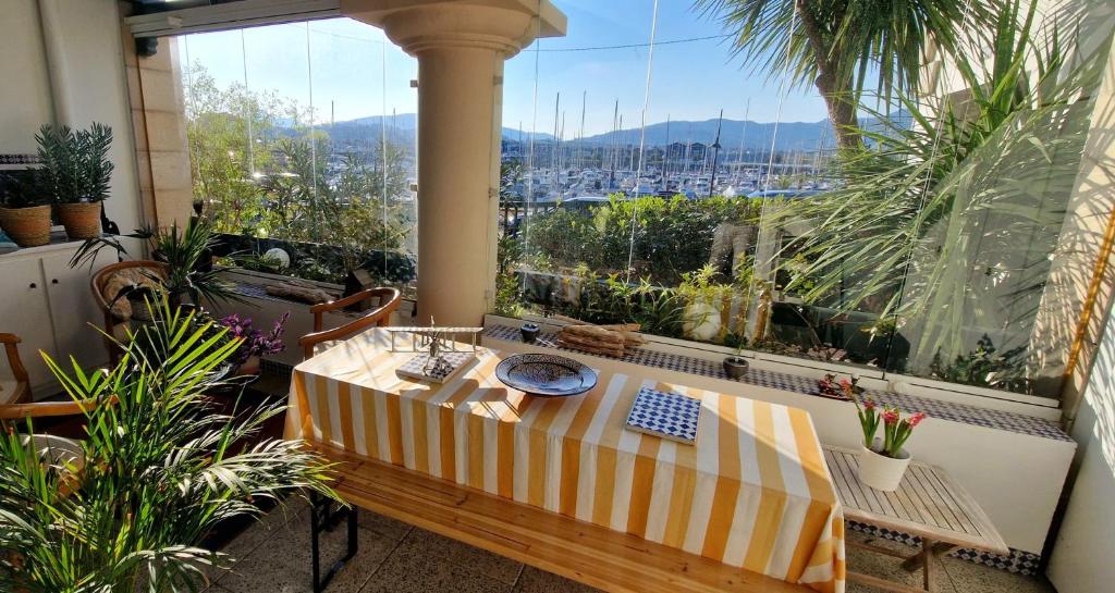 a balcony with a table and a view of a city at 2 chambres et canapé lit bureau - Marina Plage - Agréable in Hendaye