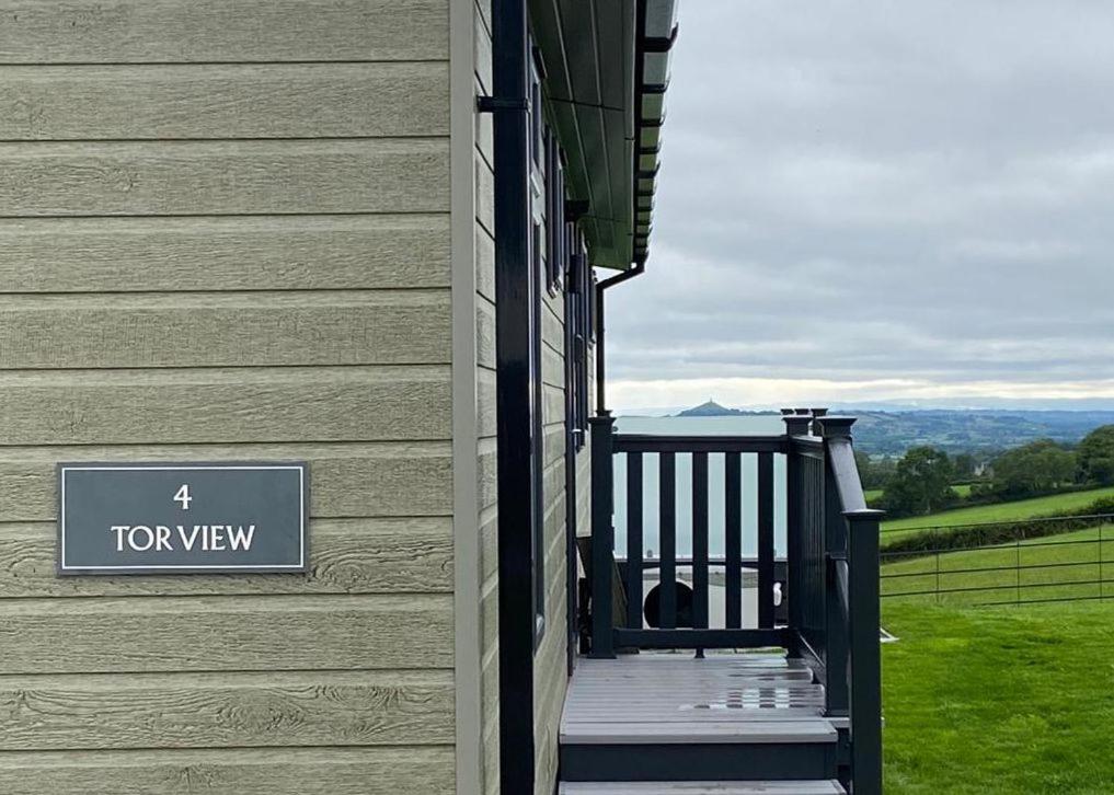a porch of a house with a toy view sign on it at Midsomer Lodges in Pilton