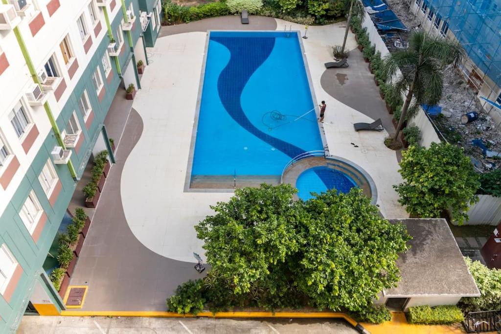 an overhead view of a swimming pool next to a building at Functional 1-br Space in Amaia with Fast Internet in Mandaue City