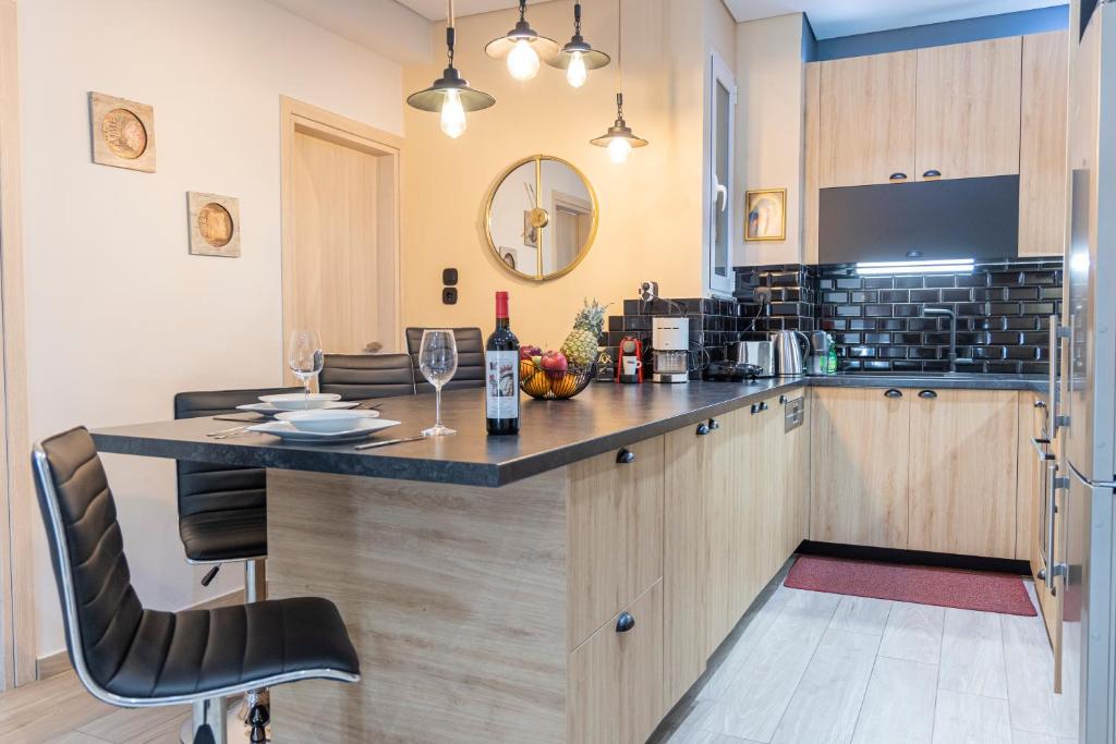 a kitchen with a bar with a bottle of wine at Piraeus Port Exclusive in Piraeus