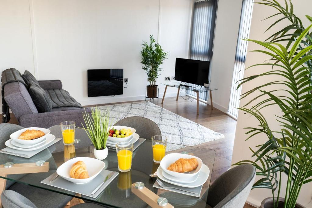 a table with plates of food on top of it at Apartment @ I Quarter in Sheffield