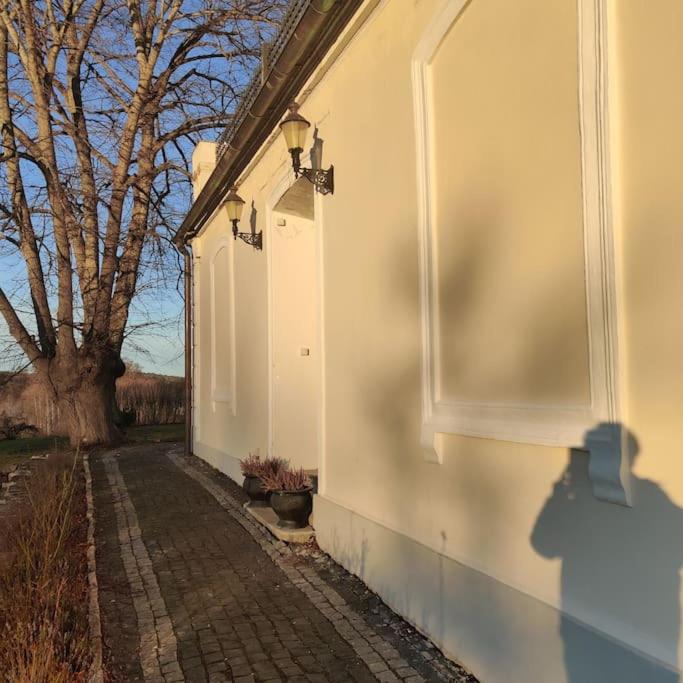 a white building with a tree on the side of it at 2 bedroom apartment in Södertälje