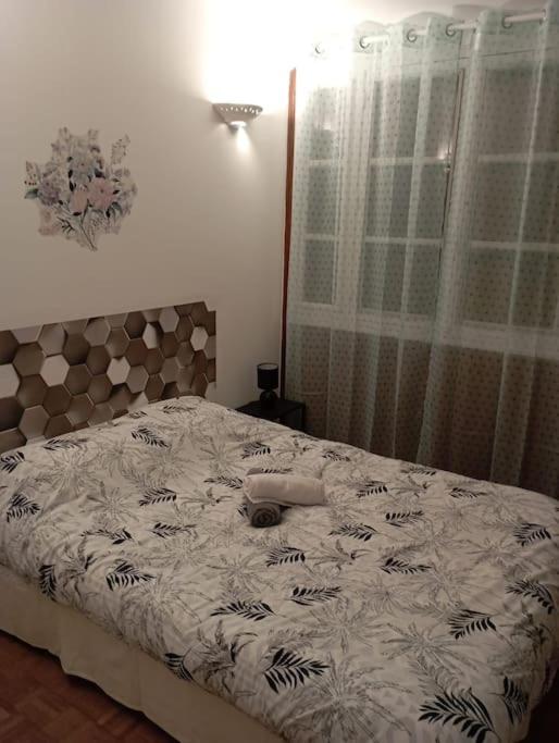 a bedroom with a large bed with a white comforter at Idéal 4 pièces, tout confort in Courcouronnes