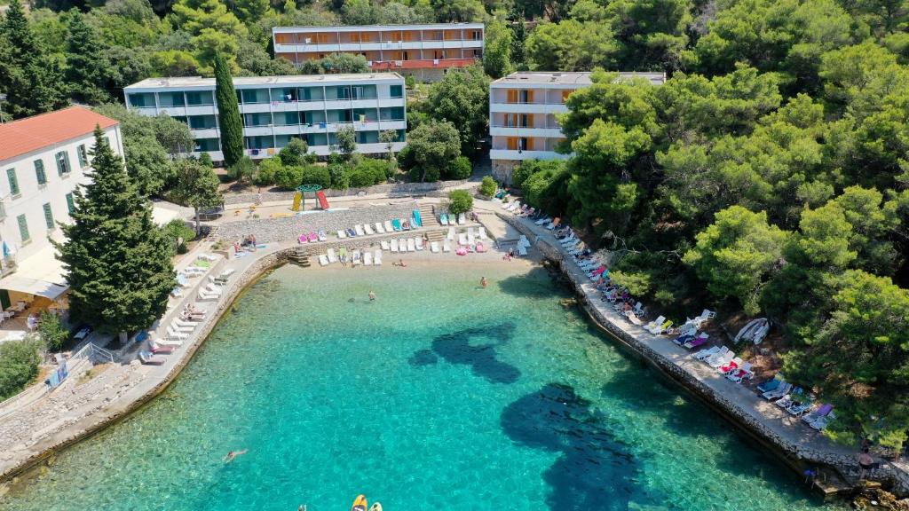 an aerial view of a beach with people in the water at Hotel Sirena Hvar in Hvar