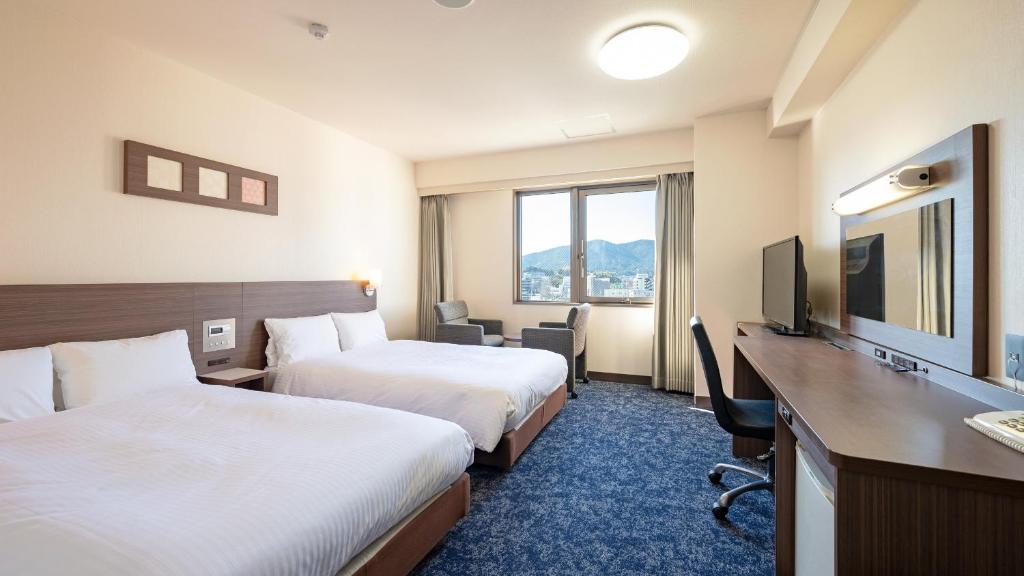 Postel nebo postele na pokoji v ubytování EN HOTEL Ise