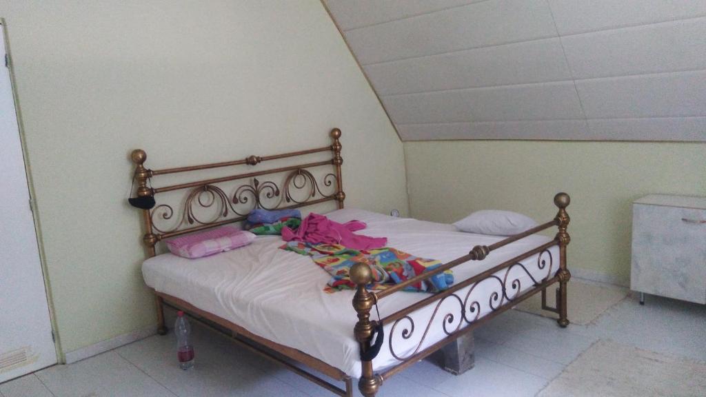 a bedroom with a wooden bed with dolls on it at SUBASA GREEN GARDEN in Szeged