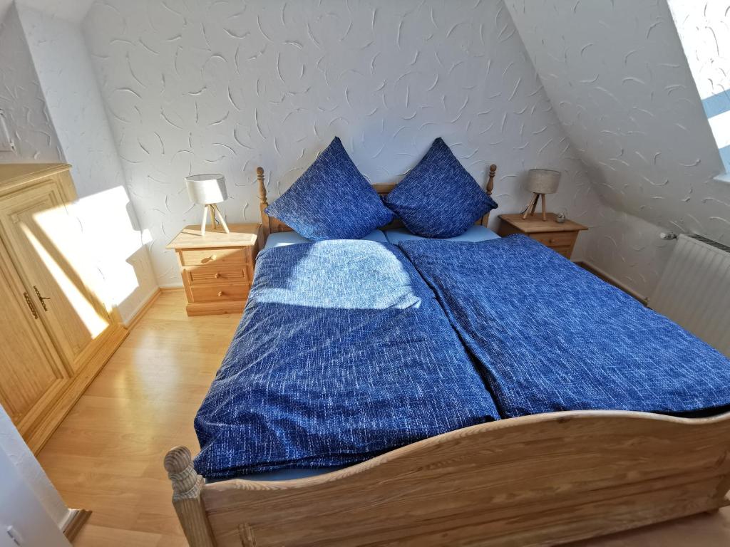 a bedroom with a blue bed with blue pillows at 300 Jahre altes Haus in der historischen Altstadt in Arnsberg