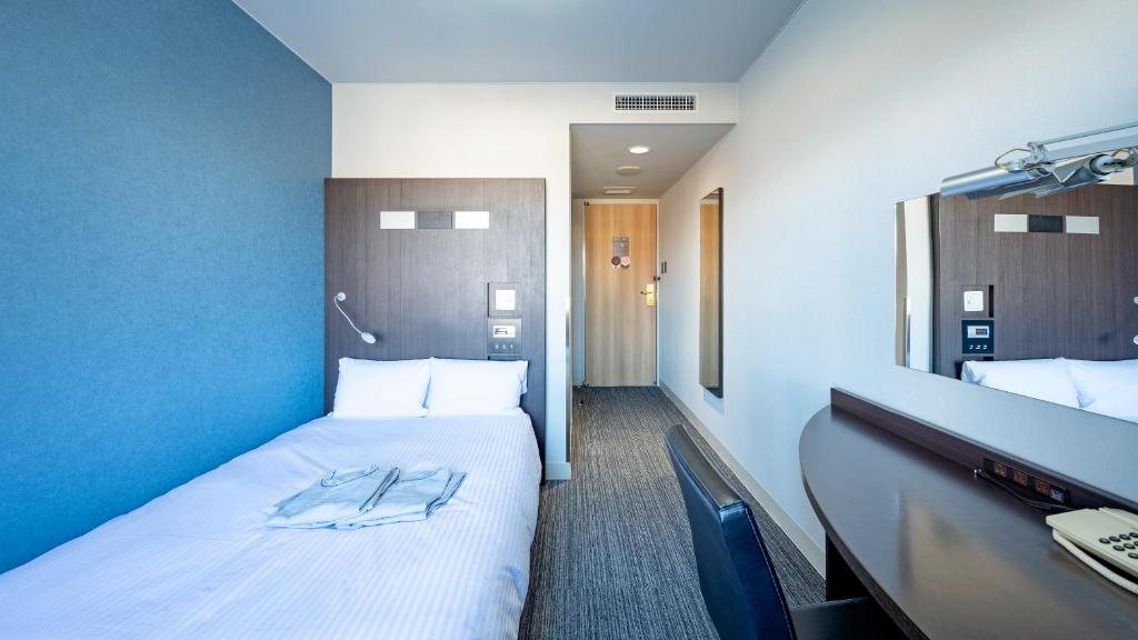 Postel nebo postele na pokoji v ubytování EN HOTEL Ise