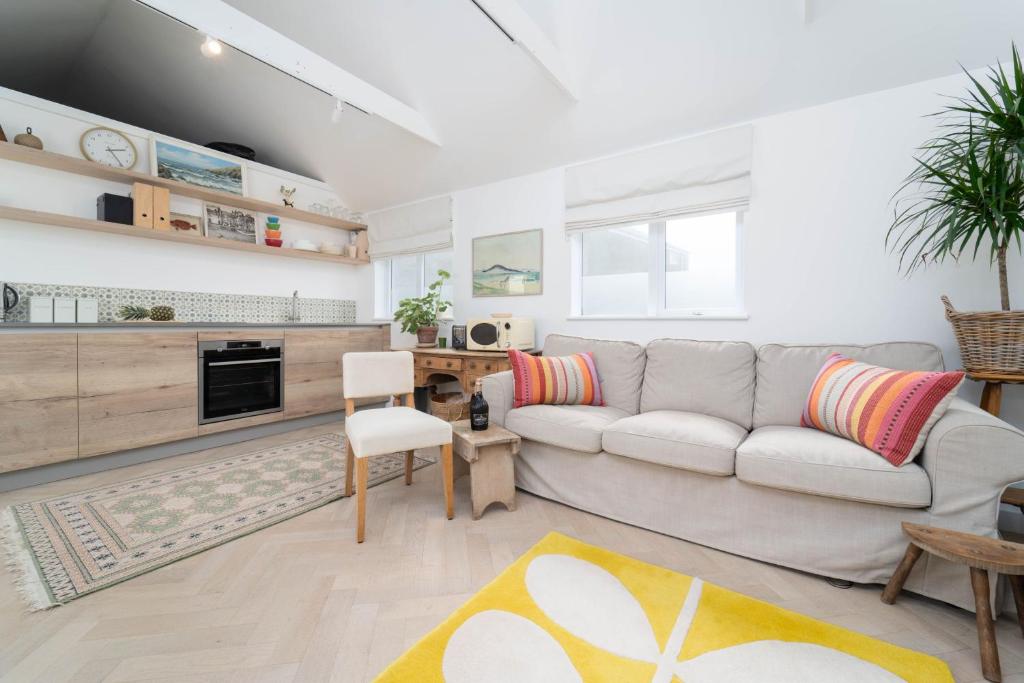 a living room with a couch and a table at 8 Beach Court in St Ives