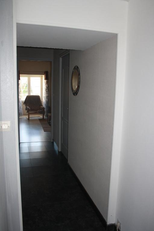 a hallway of a house with a clock on a wall at Gite De LA BALLADE in François