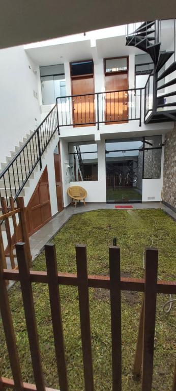 a view of a building with a staircase and grass at Pisco Bed and Sunset in Pisco