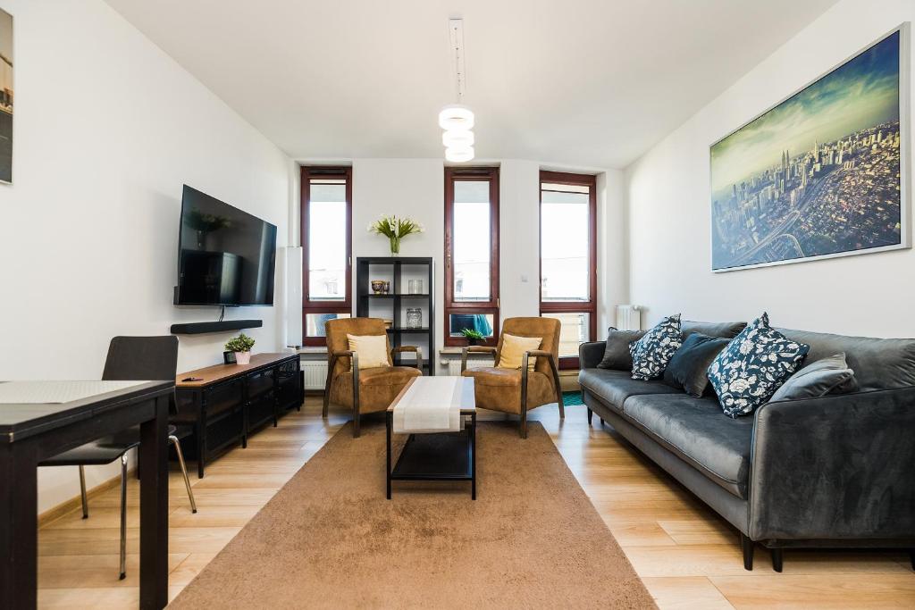 a living room with a couch and a table at ShortStayPoland Grodkowska (B114) in Warsaw