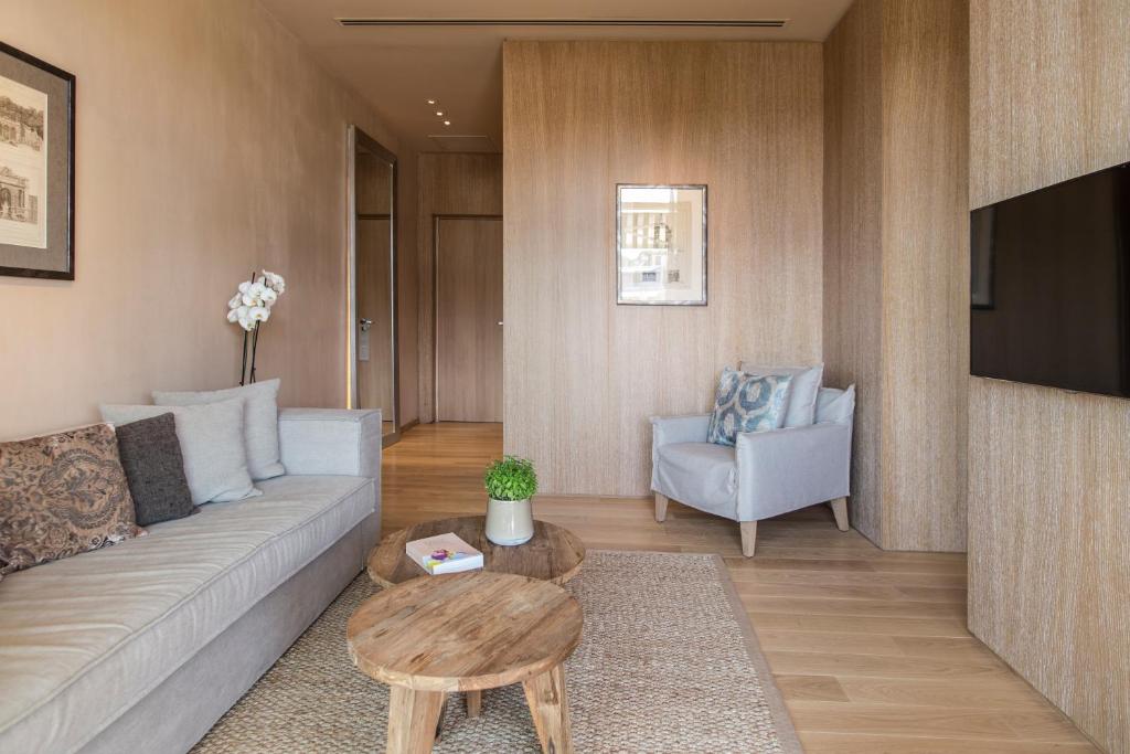 a living room with a couch and a table at The Margi in Athens