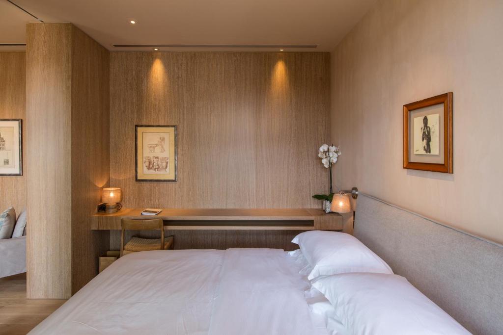 a bedroom with a white bed and a desk at The Margi in Athens