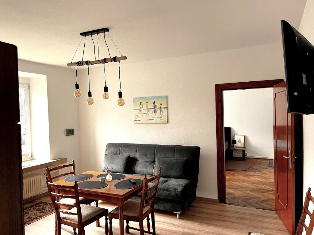 a living room with a table and a couch at Modern-Vintage Apartment in Osterholz-Scharmbeck