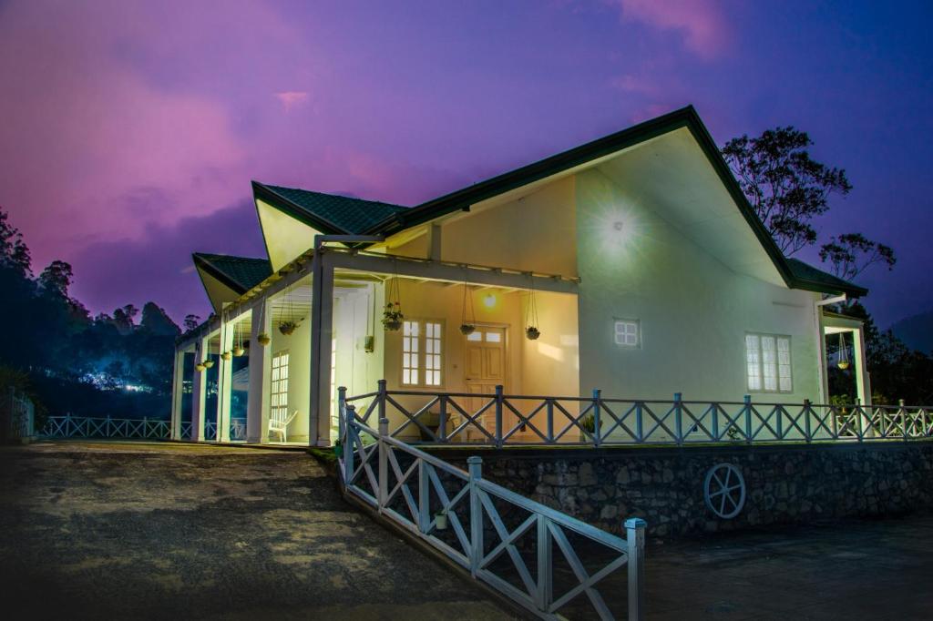 a house at night with a purple sky at Mount edge riverside hotel in Bandarawela in Bandarawela