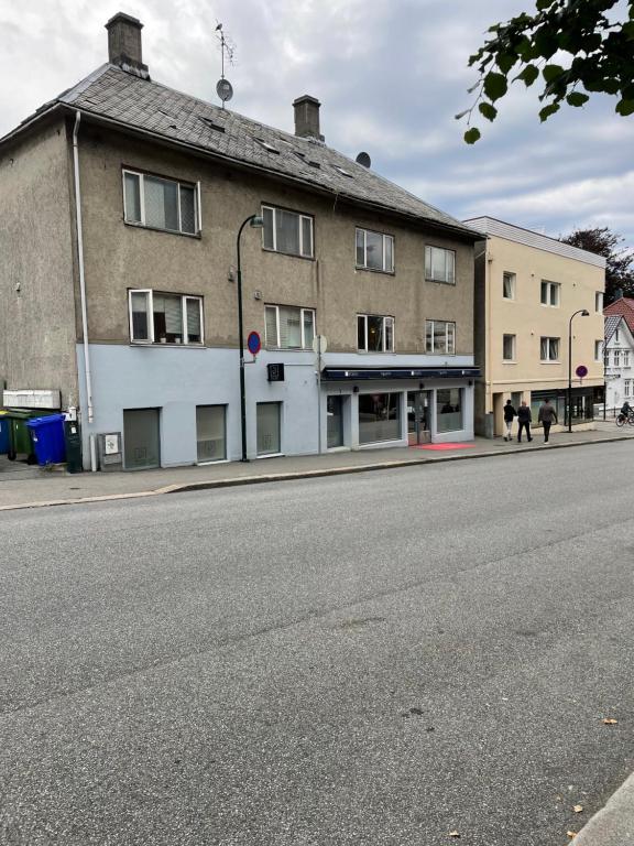 an empty street in front of a building at Eiganesveien 1 in Stavanger