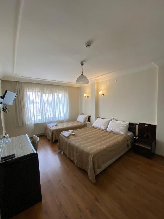 Postel nebo postele na pokoji v ubytování OTEL KING