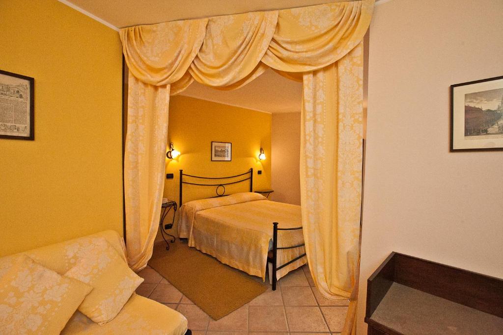 Postel nebo postele na pokoji v ubytování Hotel Rainero