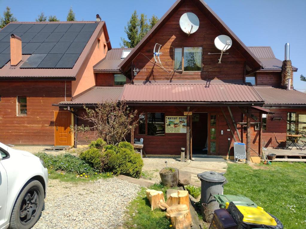 a house with solar panels on top of it at Widok in Cisna