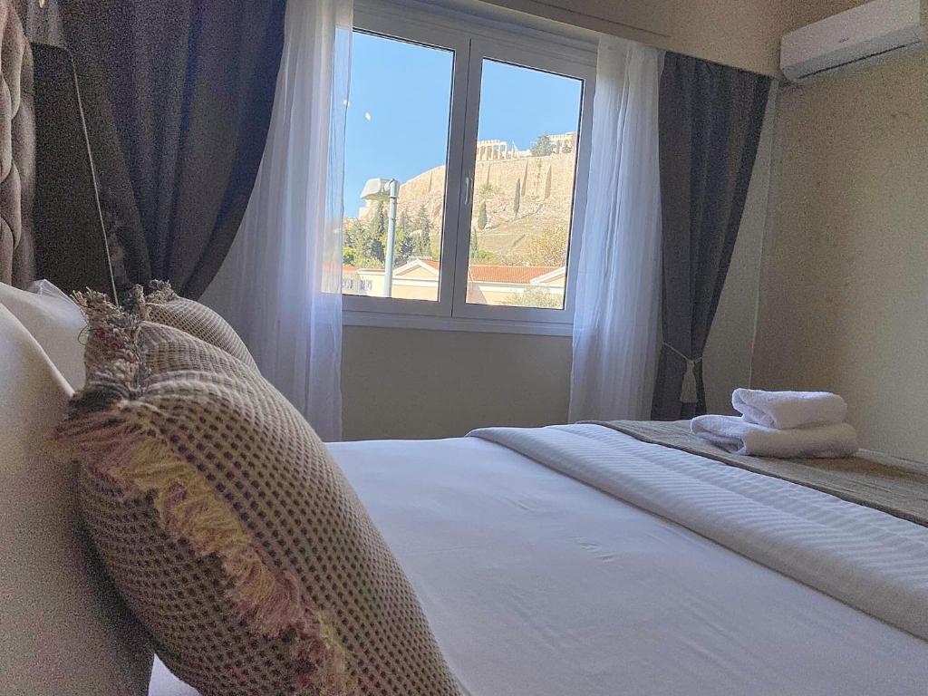 Letto o letti in una camera di Check Point - Acropolis View