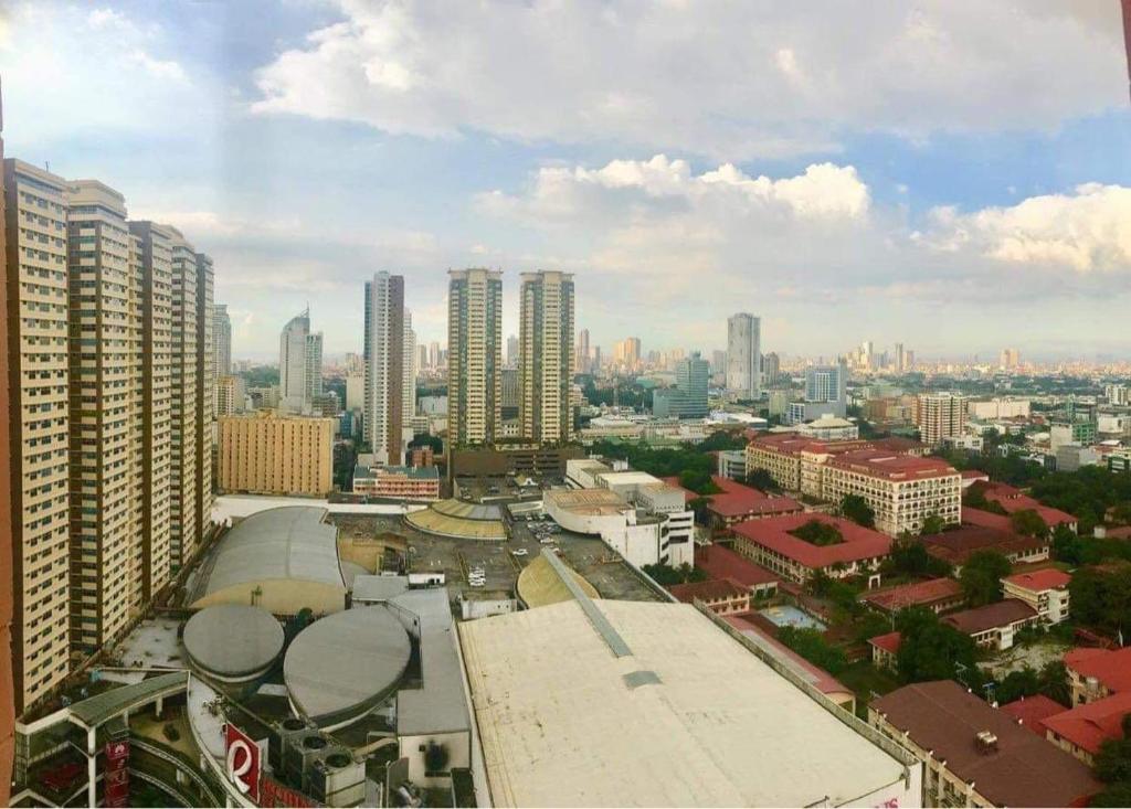 a view of a city with tall buildings at Birch Tower Private Studio with Manila City Metro View in Manila