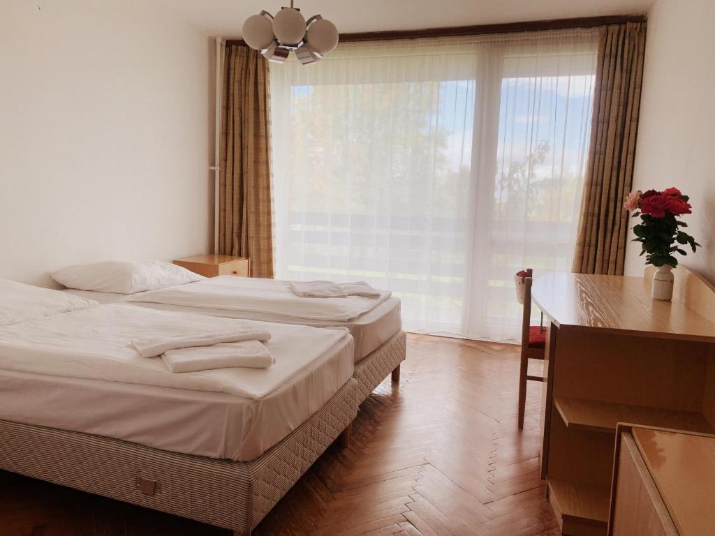 A bed or beds in a room at Riviera Park Hotel