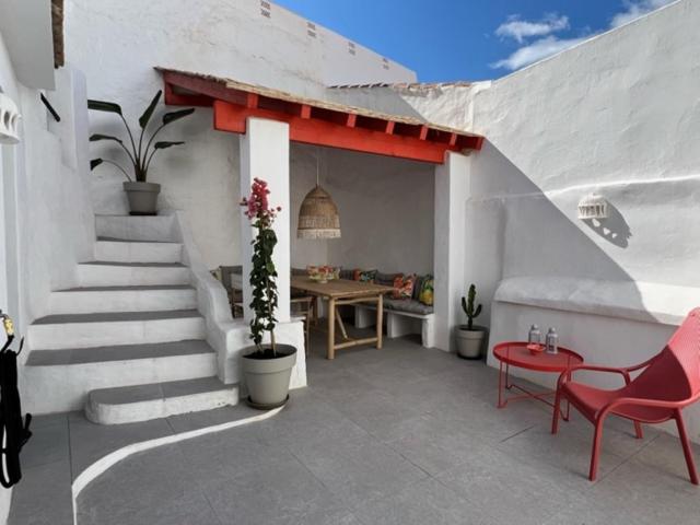 a patio with stairs and a table and a red chair at Lemon House in Vélez-Málaga