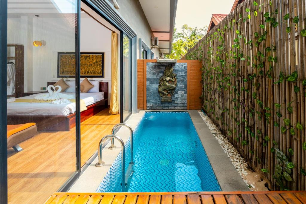 a swimming pool in the middle of a house at Nina Angkor Residence in Siem Reap