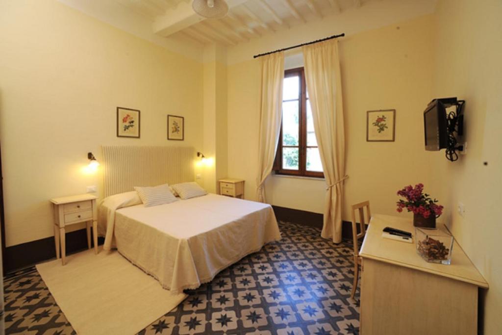 a hotel room with a bed and a window at Villa Boldrini b&b in Venturina Terme