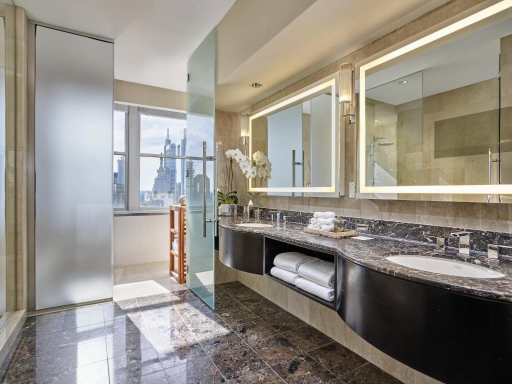 ein Badezimmer mit zwei Waschbecken und einem gro&szlig;en Spiegel in der Unterkunft Loews Philadelphia Hotel in Philadelphia