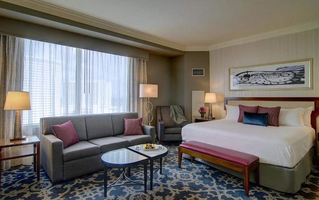 a hotel room with a bed and a couch at Loews New Orleans Hotel in New Orleans
