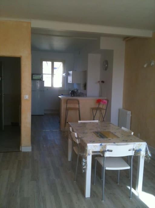 a kitchen with a table and chairs in a room at Vaste appartement avec vue sur la Vienne in Chinon