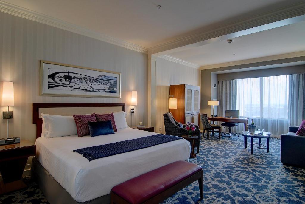 a hotel room with a bed and a living room at Loews New Orleans Hotel in New Orleans