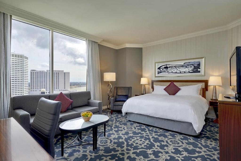 a hotel room with a bed and a couch at Loews New Orleans Hotel in New Orleans