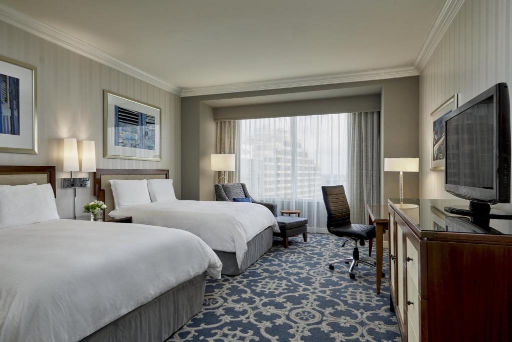 a hotel room with two beds and a flat screen tv at Loews New Orleans Hotel in New Orleans