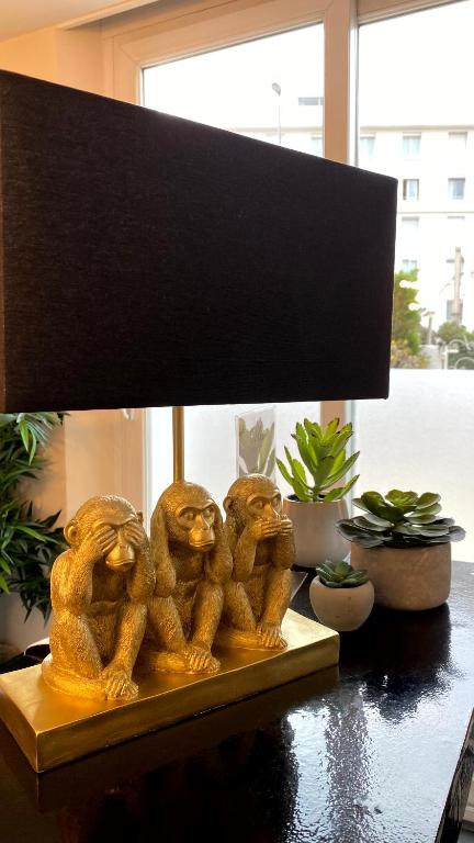 a group of monkey statues sitting on a table at Hôtel La Villa Cannes in Cannes