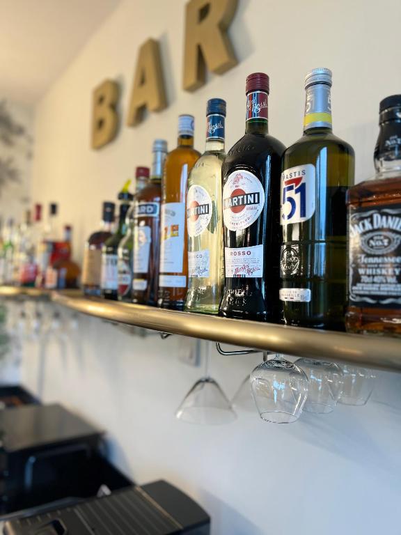 a row of bottles of alcohol on a shelf at Hôtel La Villa Cannes in Cannes