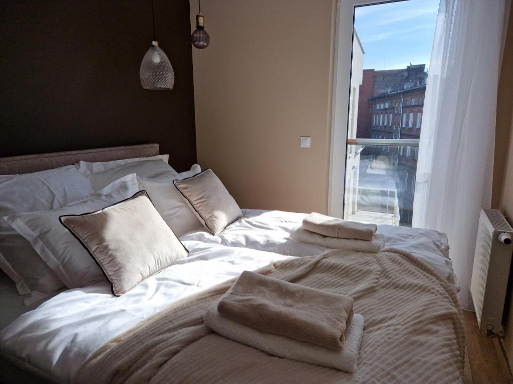Posteľ alebo postele v izbe v ubytovaní Apartament My City