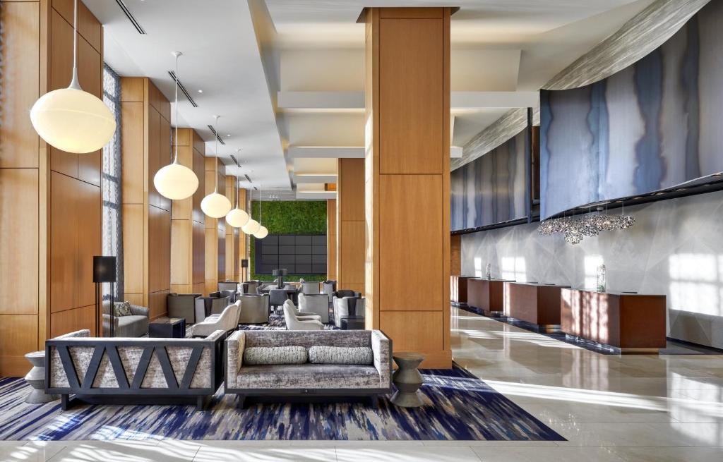 a lobby of a hotel with couches and chairs at Loews Chicago O'Hare Hotel in Rosemont