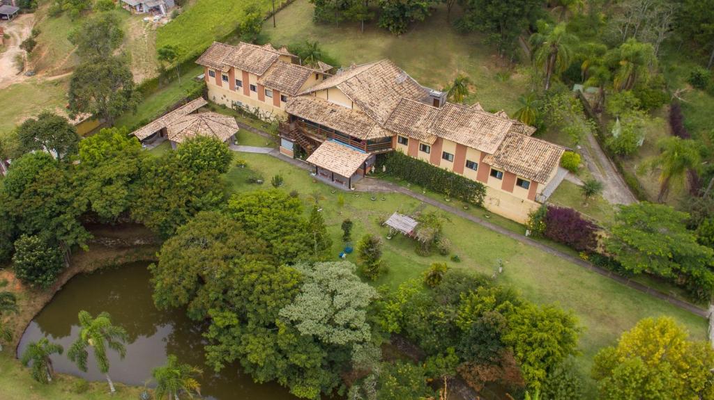 an aerial view of a large house with a river at Pousada Ventos de Outono in São Roque