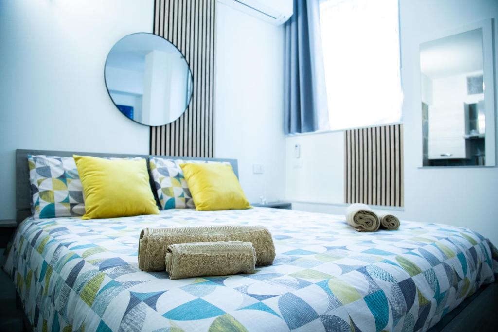 a bedroom with a bed with towels on it at STUDIO 47 - CITY LIFE in Milan